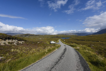 Driving on a loneley road through the beautiful scottish moorland, Assynt, Scotland