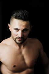 Fototapeta premium Young athletic man showing muscular torso