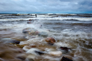 During the storm, the old pier is under water.