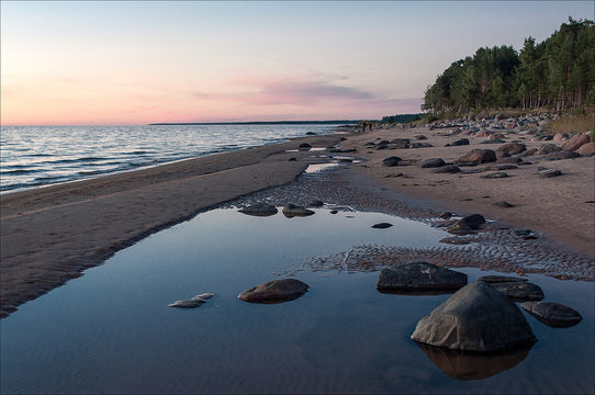 Fototapeta Sea landscape. Rocky beach at sunset.