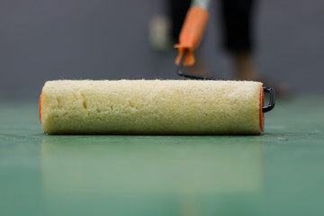 The painters are painting the green floor.