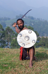 Indian fighter performing Kalaripayattu marital art demonstration in Kerala, India
