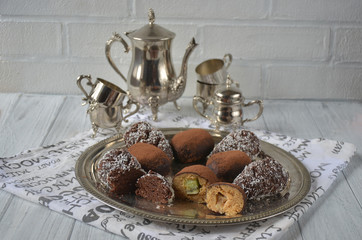 Chocolate rum balls cakes decorated with cream and coconut