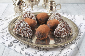 Chocolate rum balls cakes decorated with cream and coconut