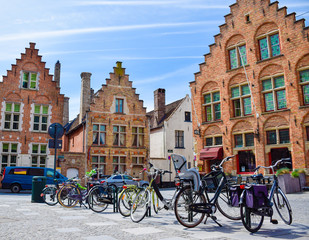 Fototapeta na wymiar Bicycles are parked in front of historical medieval brick buidlings
