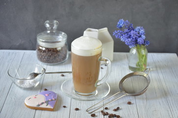 Cup of coffee, tasty cake and beautiful bouquet of flowers in cafe