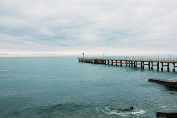 Fototapeta na wymiar Lighthouse on the pier. Black Sea. Sochi