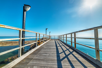 Naklejka premium Wooden boardwalk in Marina di Cardedu