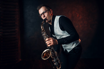 Fototapeta na wymiar Male saxophonist playing classical jazz on sax