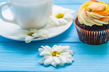 Still life with cup of tea and cake on the wooden background