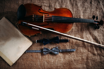 Violin, fiddlestick, notes and bowties closeup
