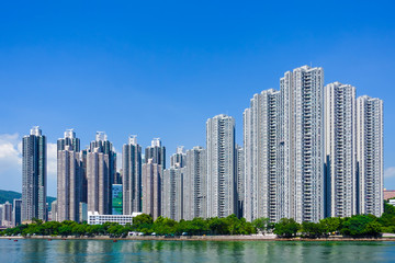 View of modern apartment buildings on the waterfront site with blue sky as a background and copy space