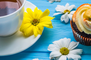 Fototapeta na wymiar Still life with cup of tea and cake on the wooden background