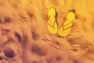 Summer beach fun - yellow flip-flops with seagull footprints, retro toned