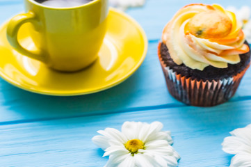 Still life with cup of tea and cake on the wooden background