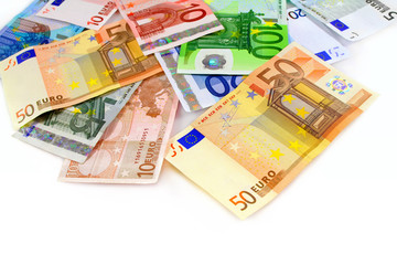 Pile of euro currency banknotes on white background