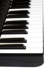 Piano keyboard with white and black keys on white background side view vertical  photo close up