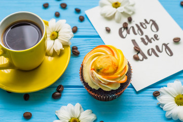 Still life with cup of tea and cake on the wooden background