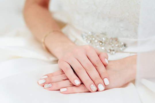 the bride's hand with a manicure