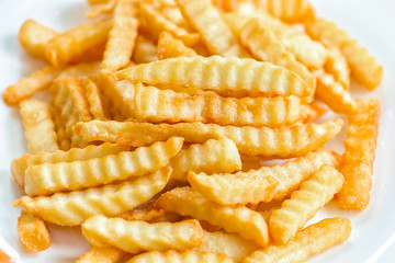French fries with ketchup on wooden background.