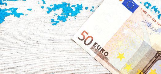 Banknote of 50 euro on the wooden background. Close up.