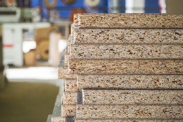 A pack of parts of a particleboard in the furniture manufacturing.
