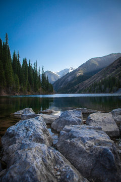 Majestic blue mountain lake with green trees