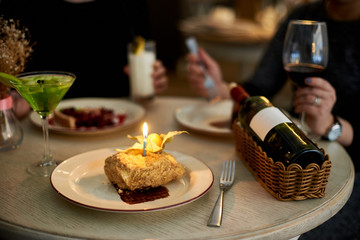 Girls party in cafe. Young woman drinking cocktails and wine and eating cakes. Female hands.