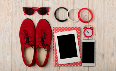 Red women shoes oxfords, bracelets and sunglasses, smartphone and e-book.