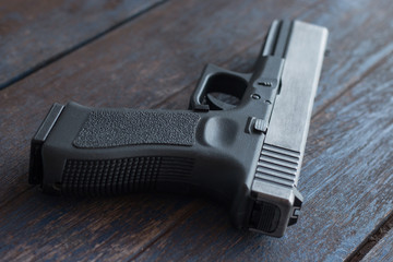 Gun handle close up on wooden background