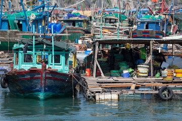 Fototapeta na wymiar Floating fishing village with rock island in background, Ha Long bay, Vietnam.