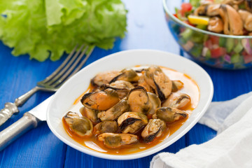 mussels in sauce on white dish