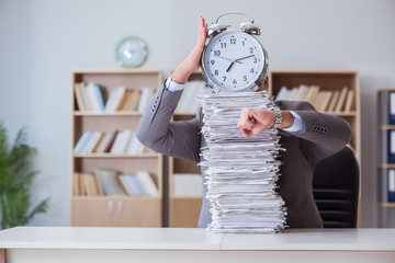 Businessman busy with paperwork in office