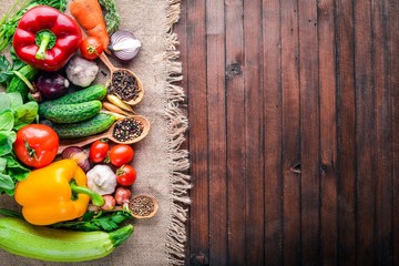 Frame of organic food. Fresh raw vegetables and spices. On a wooden chalkboard.