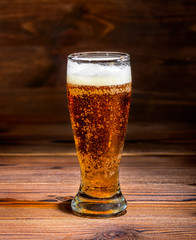 dark glass beer on rustic table wood background