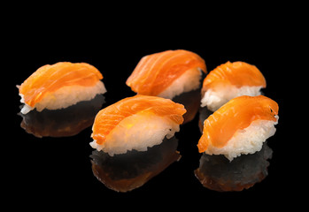 Japanese sushi nigiri with salmon isolated on black background with reflection, concept of  healthy lifestyle