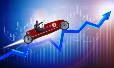 Obraz na płótnie Canvas Businessman riding sports car against charts