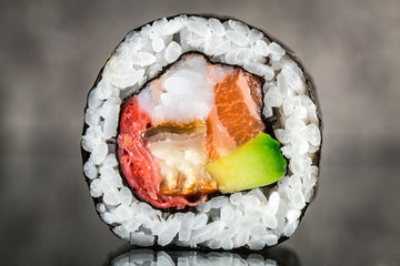 Sushi roll with salmon, shrimps and avocado