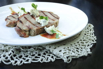 Grilled meat with sauce and cheese