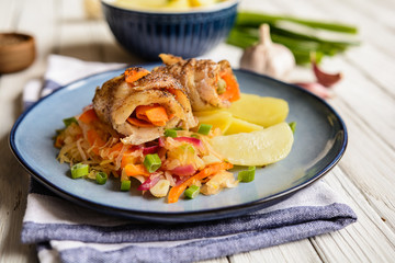 Pangasius fillets rolls stuffed with carrot and olives, served with vegetable salad and boiled potato