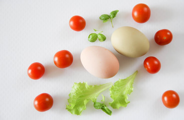 Fresh organic free range eggs with cherry tomatoes. Food design isolated on white background. 