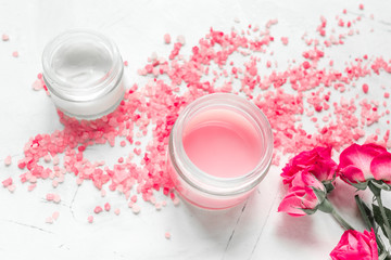 Fototapeta na wymiar rose salt and cream for nail care in spa on white background
