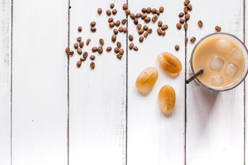 Ice coffee with milk for lunch on white wooden background top view