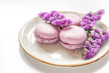 Trendy woman pattern with spring flowers and macaroons on plate