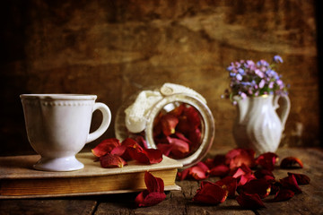 Fototapeta na wymiar retro effect on photo vintage tea with rose dry petal