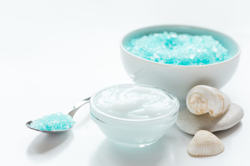 set for bath with blue salt and shells on white table background