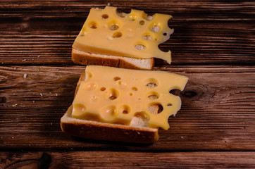 Sandwich with cheese on wooden table