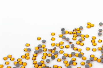 Precious sparkling rhinestones Topaz colors on a white background.