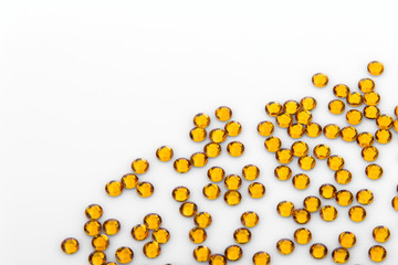 Precious sparkling rhinestones Topaz colors on a white background.
