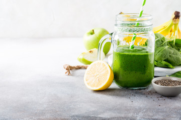 Healthy breakfast with green smoothie in glass jar and ingredients. Detox, diet, healthy,...